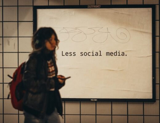 a woman standing in front of a sign that says less social media